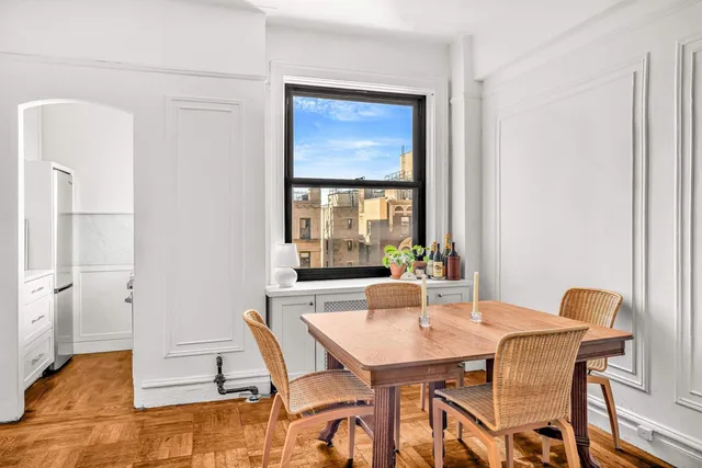a dining room with furniture and wooden floor