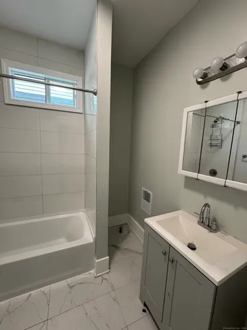 a bathroom with a bathtub and a sink