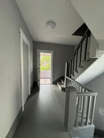 a view of entryway and hall with wooden floor