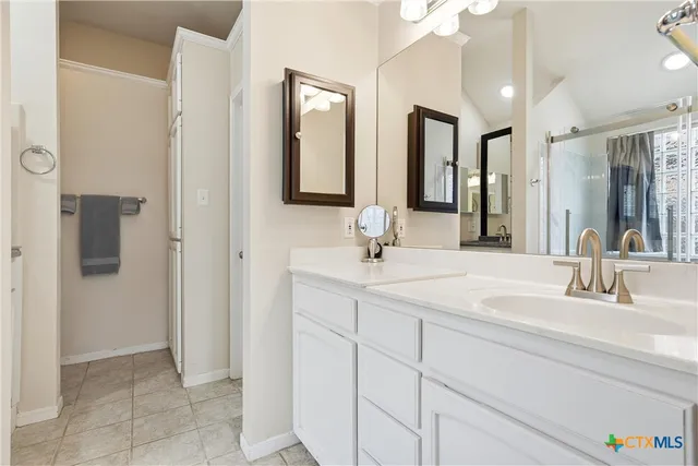 a bathroom with a double vanity sink and mirror