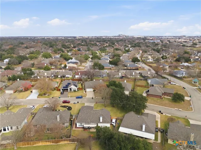 an aerial view of residential building with yard
