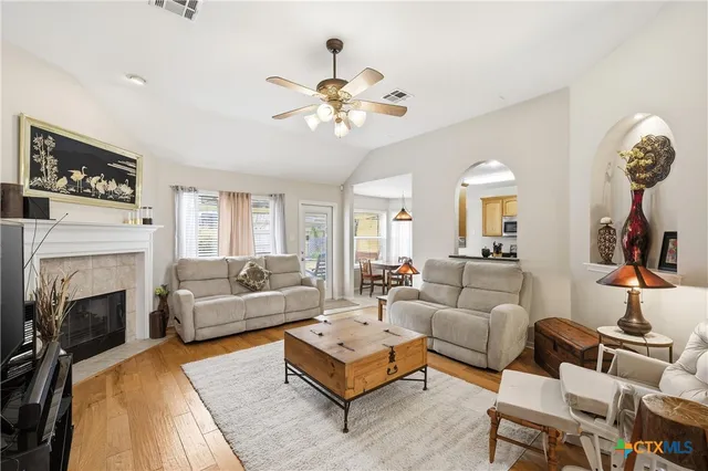 a living room with furniture a fireplace and a flat screen tv