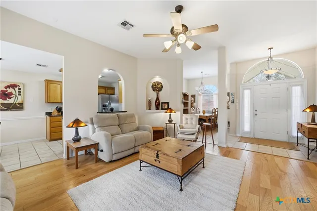 a living room with furniture and a chandelier