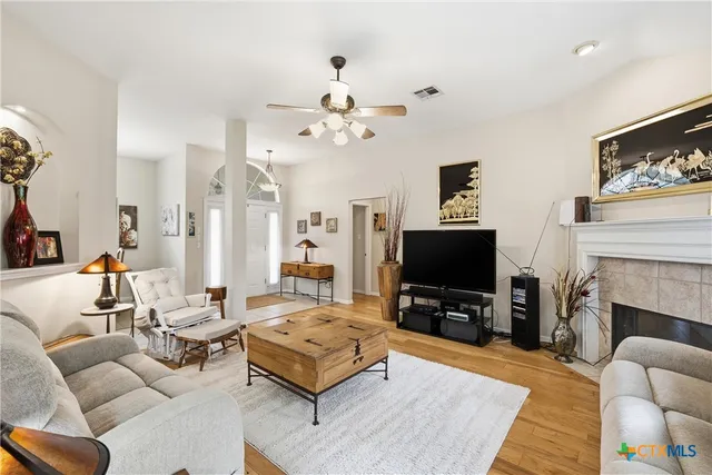 a living room with furniture a flat screen tv and a fireplace