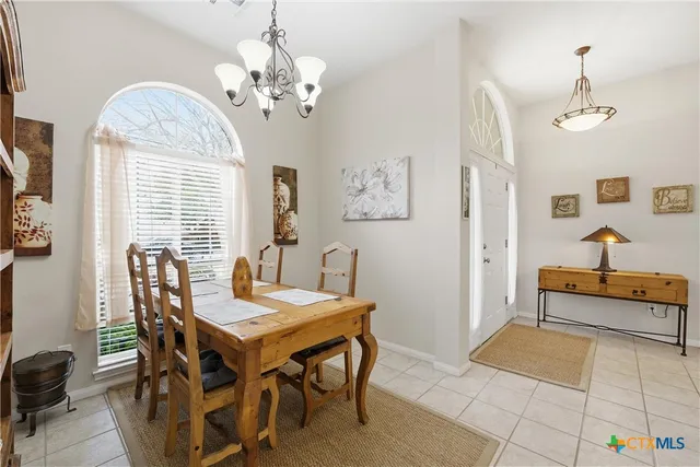 a view of a dining room with furniture and a chandelier
