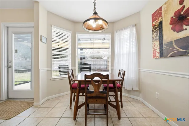 a dining room with furniture and window