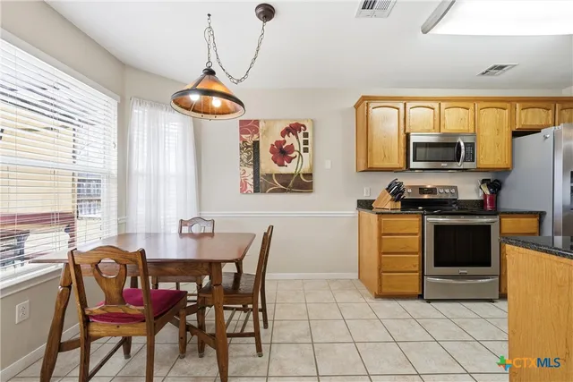 a view of a dining room with furniture and window