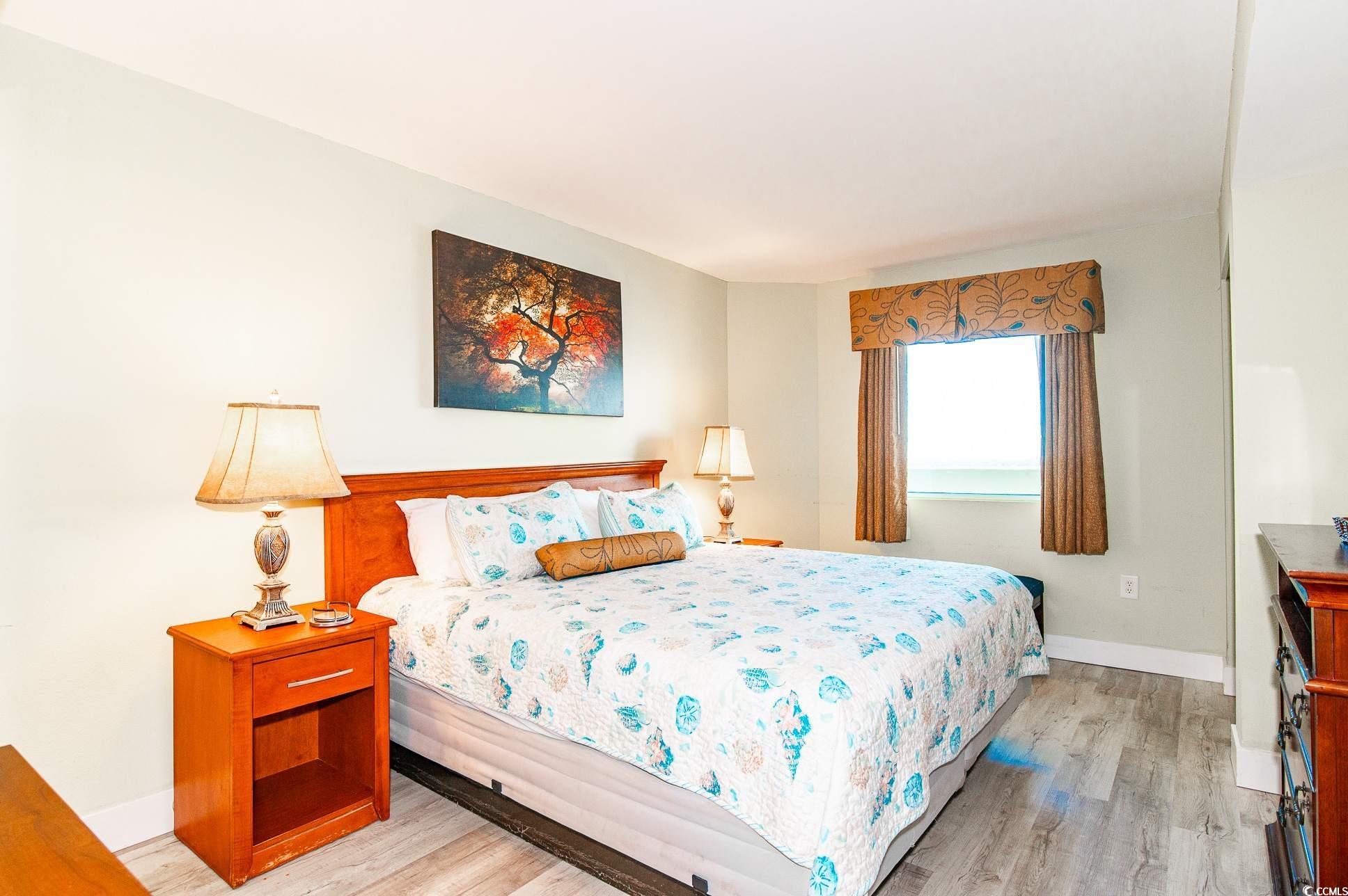 2504 North Ocean Boulevard, Unit 1835 Myrtle Beach, SC 29577 - Photo 12 of 25 Bedroom featuring light wood-style floors and baseboards