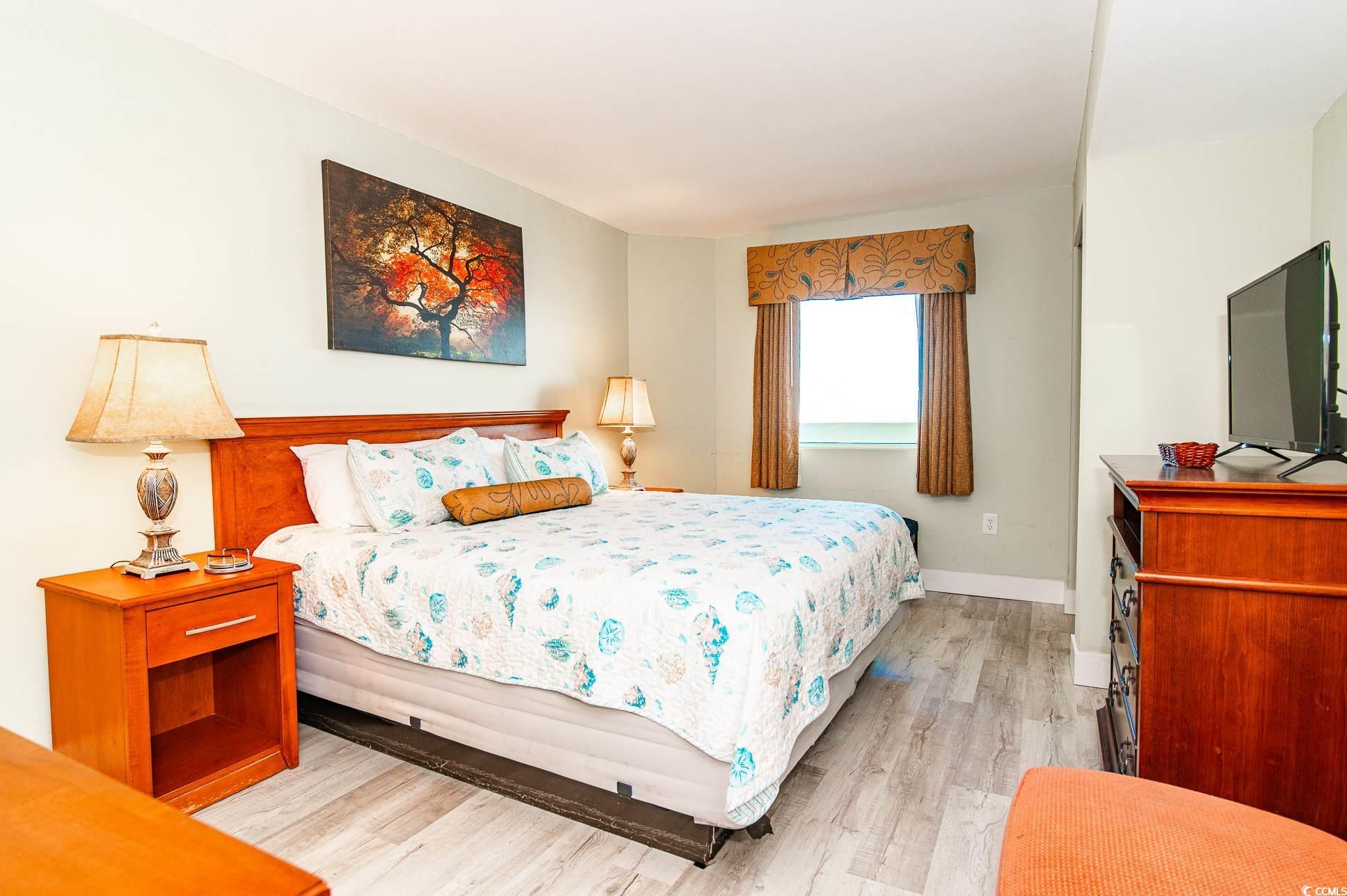 2504 North Ocean Boulevard, Unit 1835 Myrtle Beach, SC 29577 - Photo 14 of 25 Bedroom featuring light wood-type flooring and baseboards