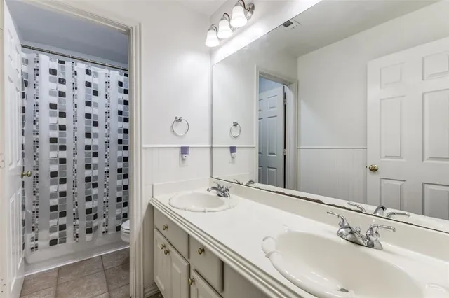 a bathroom with a sink shower and a mirror