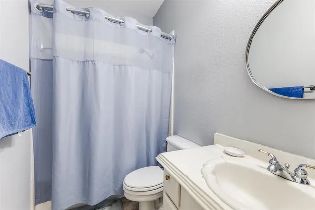a white toilet sitting next to a bathroom sink