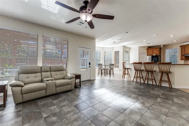 a living room with furniture and kitchen view