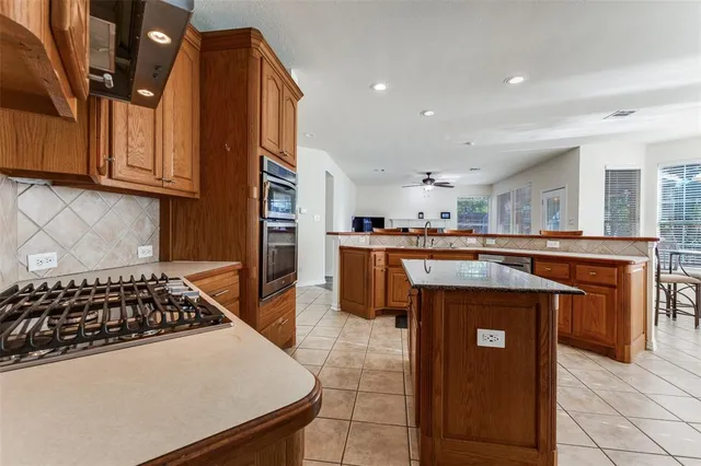 a kitchen with stainless steel appliances granite countertop a stove a sink dishwasher and cabinets