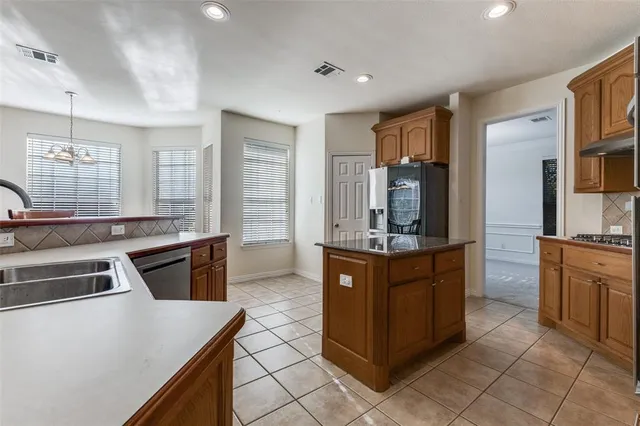 a kitchen with stainless steel appliances granite countertop a stove and a refrigerator