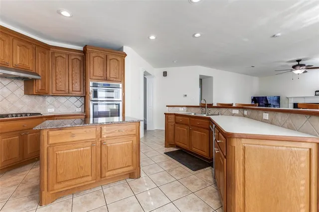 a kitchen that has a sink and a stove top oven