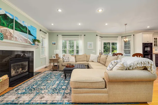 a spacious bedroom with a bed a dresser and a book shelf