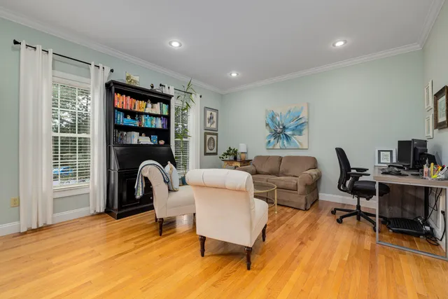 a bedroom with a bed and paintings on the wall
