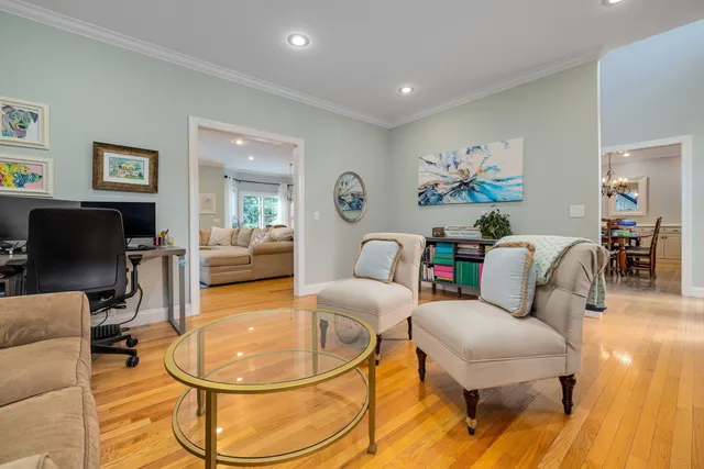 a bedroom with a bed a desk and chair with a window