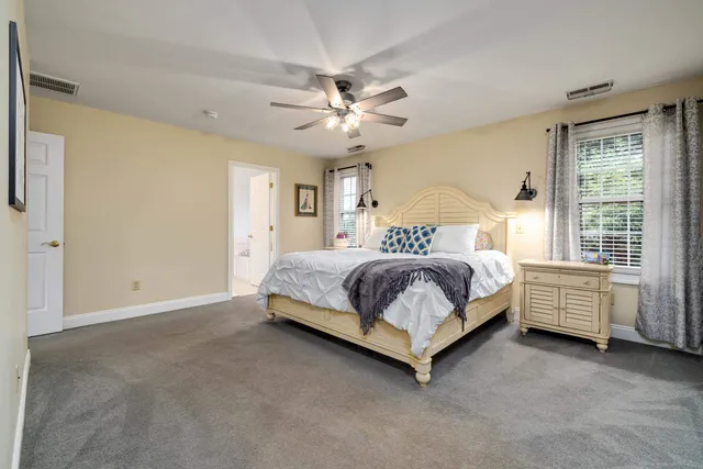 an aerial view of a house with a yard and lake view