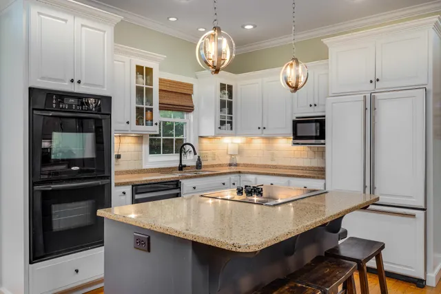 a view of a dining room with furniture wooden floor and chandelier