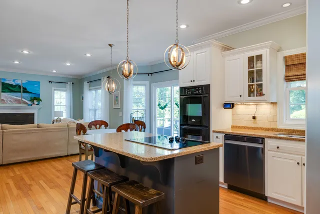 a living room with furniture large window and a fireplace