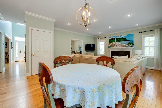 a bedroom with a bed chandelier and a window