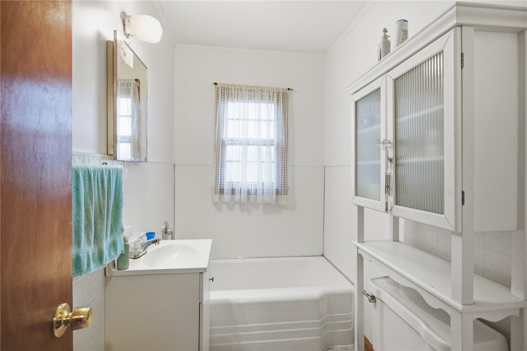 282 West Bennett Road Westminster, SC 29693 - Photo 25 of 42 This bathroom features a sleek vanity, modern tub, and a window for natural light.