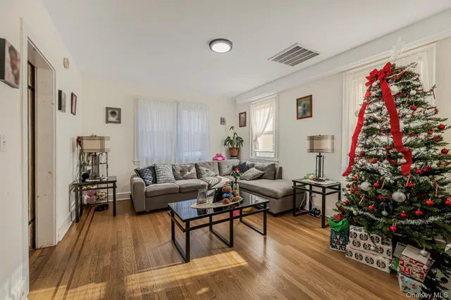 a living room with furniture and flowers
