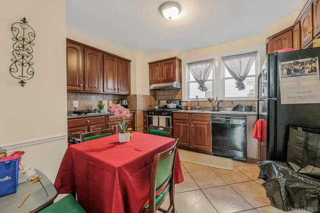 a kitchen with a sink dishwasher a stove and a refrigerator with wooden floor