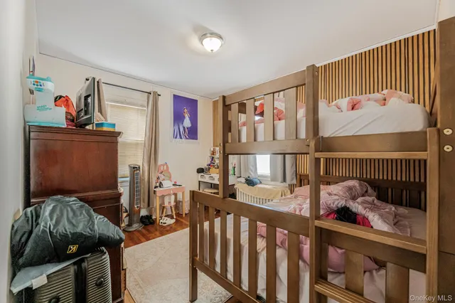 a bedroom with furniture a baby crib and a book shelf