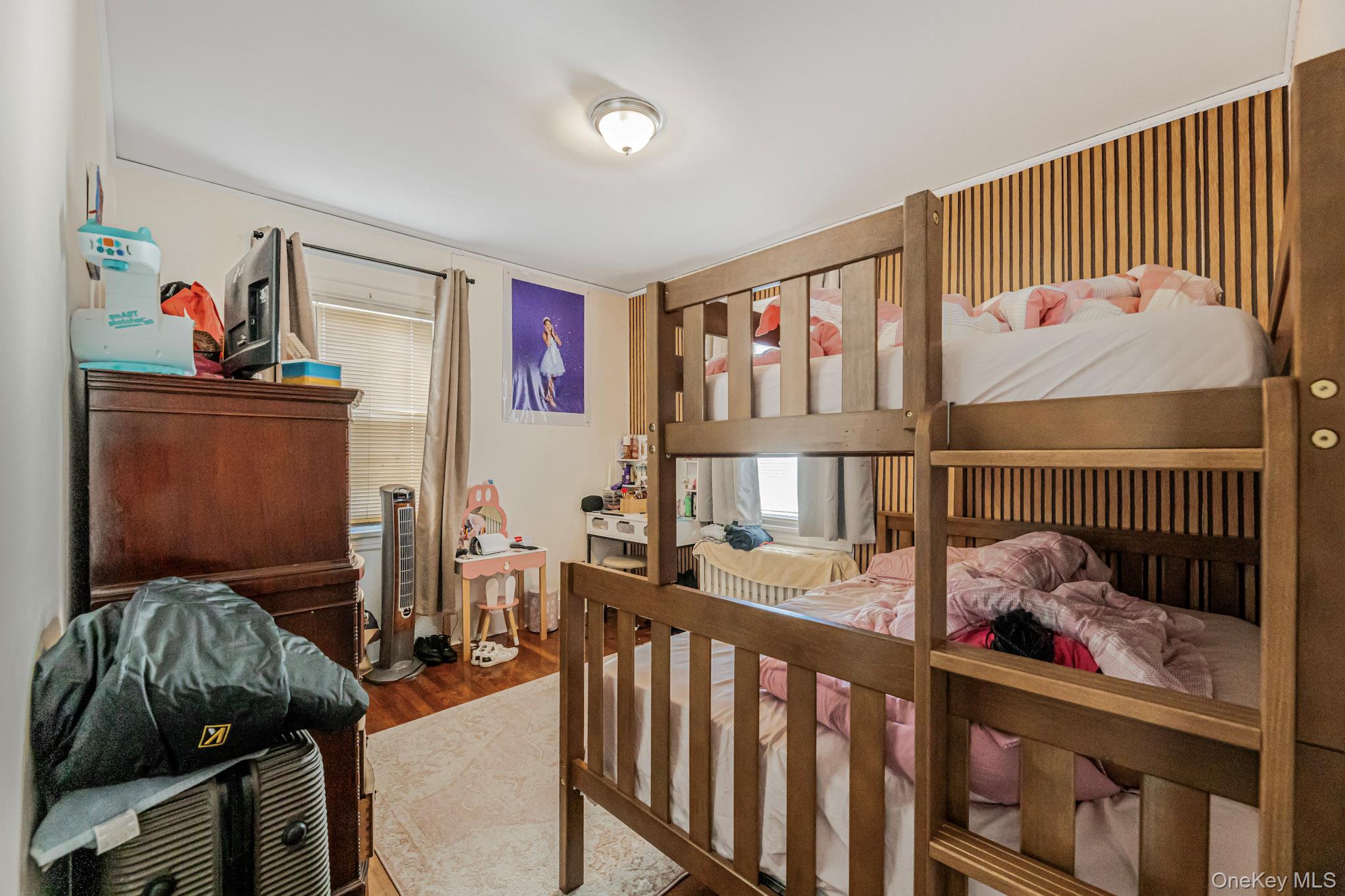 168 Stephenson Boulevard New Rochelle, NY 10801 - Photo 20 of 21 a bedroom with furniture a baby crib and a book shelf