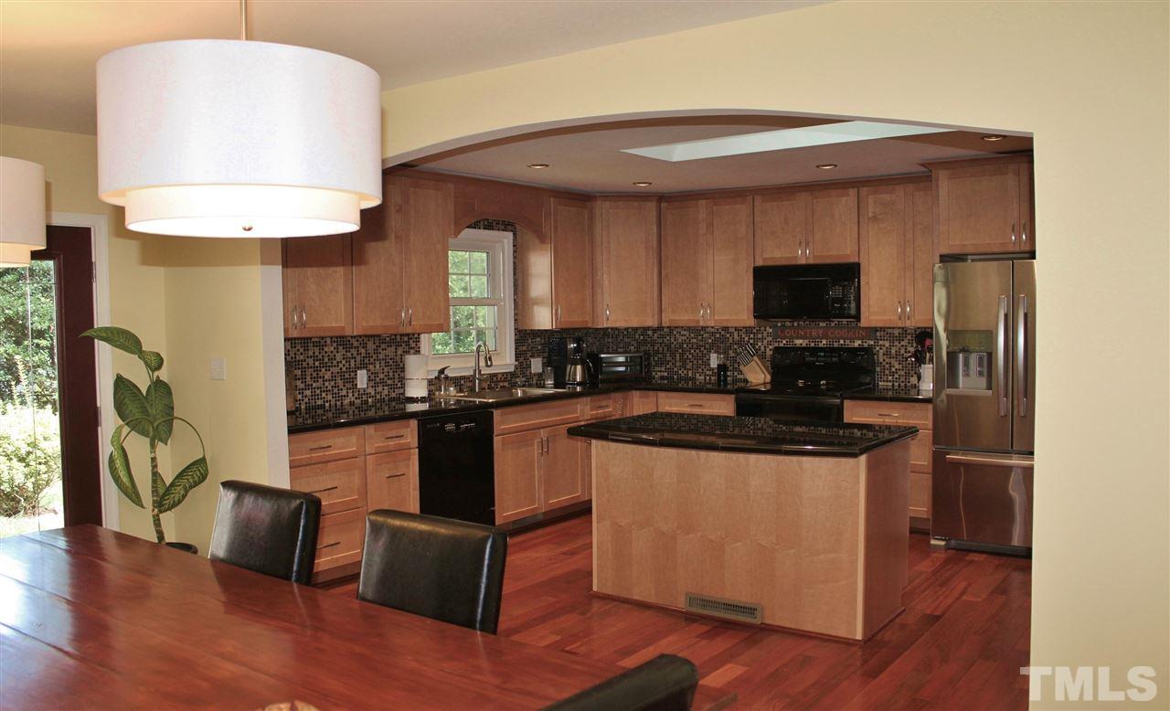 4004 Grimstead Lane Raleigh, NC 27613 - Photo 2 of 25 a kitchen with stainless steel appliances granite countertop a stove a sink and a microwave