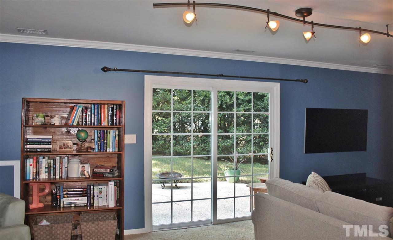 4004 Grimstead Lane Raleigh, NC 27613 - Photo 11 of 25 a living room with furniture and a flat screen tv