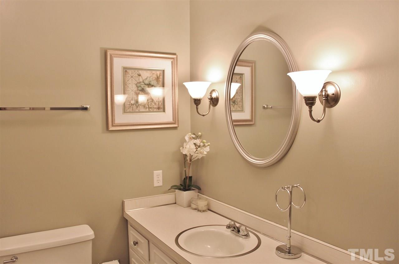 4004 Grimstead Lane Raleigh, NC 27613 - Photo 18 of 25 a bathroom with a granite countertop toilet sink and mirror