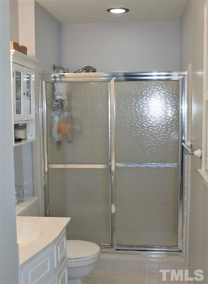 4004 Grimstead Lane Raleigh, NC 27613 - Photo 20 of 25 a bathroom with a shower a toilet and sink