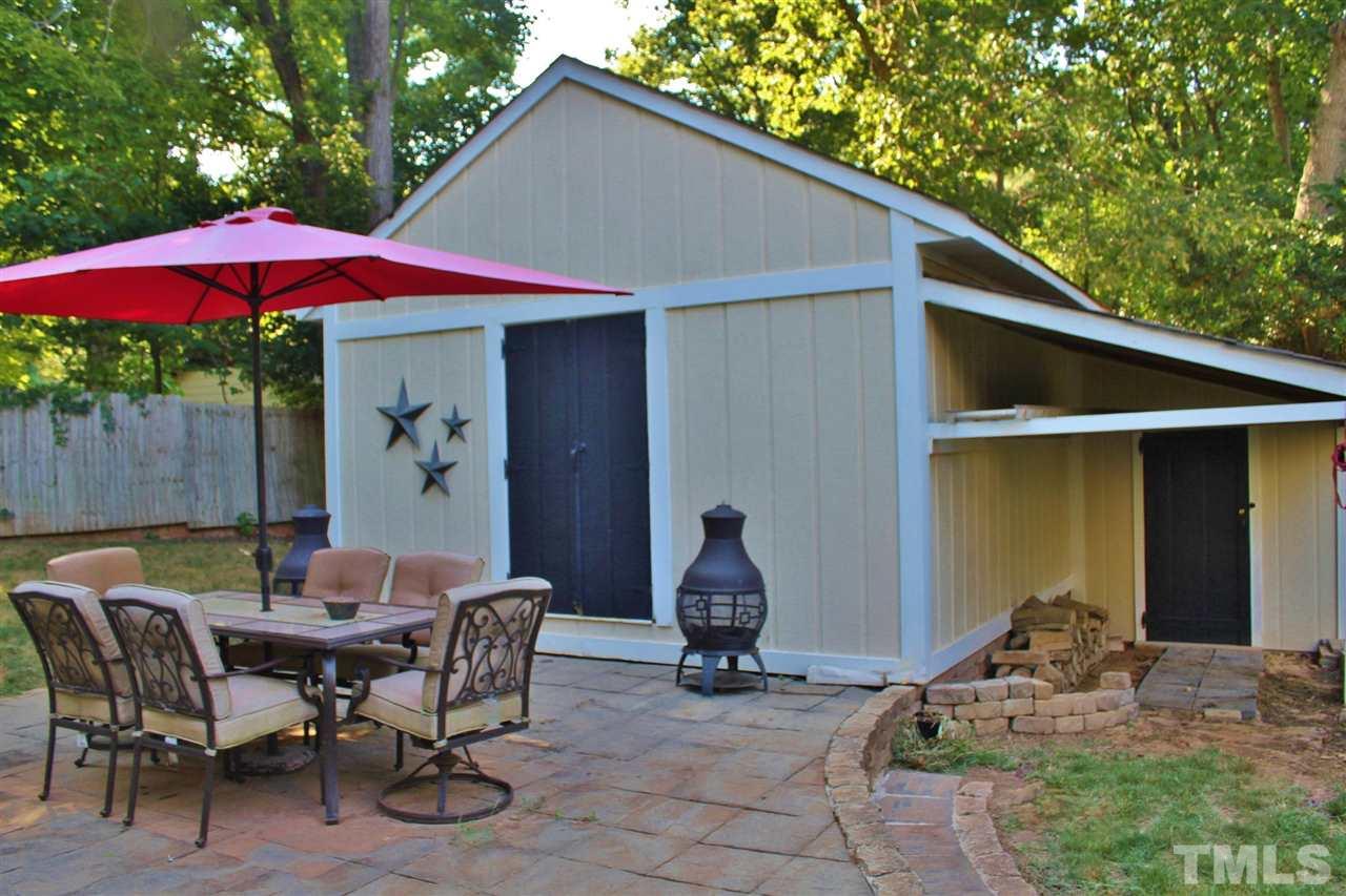 4004 Grimstead Lane Raleigh, NC 27613 - Photo 23 of 25 a backyard of a house with table and chairs