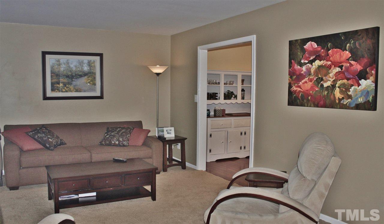 4004 Grimstead Lane Raleigh, NC 27613 - Photo 7 of 25 a living room with furniture and painting on the wall