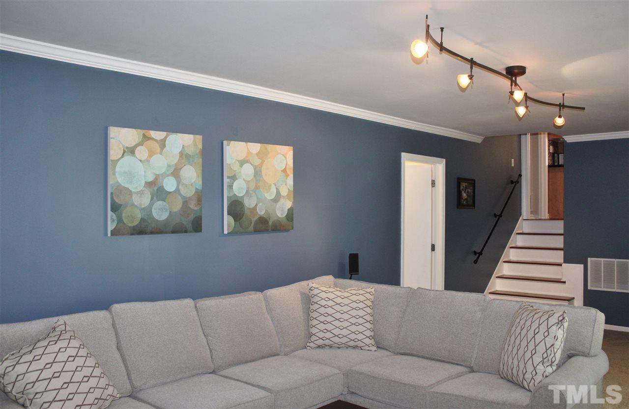 4004 Grimstead Lane Raleigh, NC 27613 - Photo 8 of 25 a living room with furniture and a large window