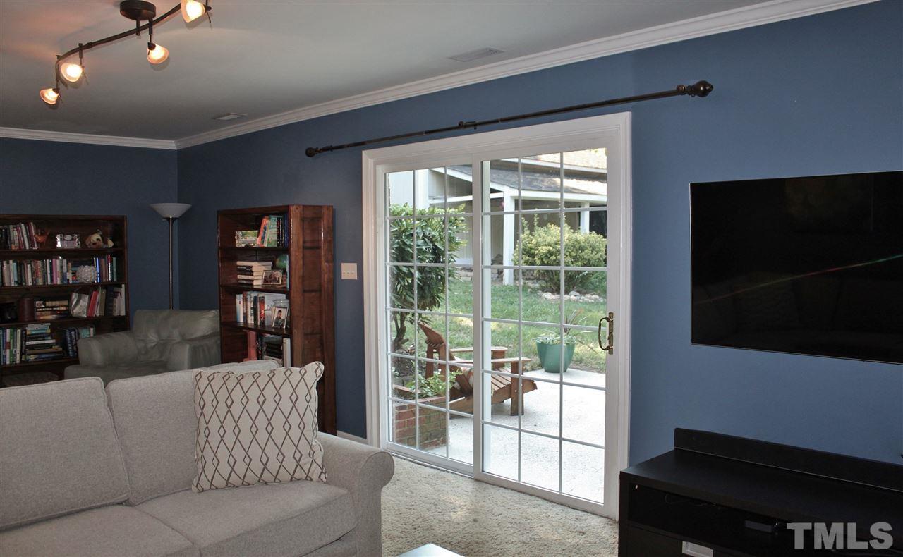 4004 Grimstead Lane Raleigh, NC 27613 - Photo 9 of 25 a living room with furniture and a flat screen tv