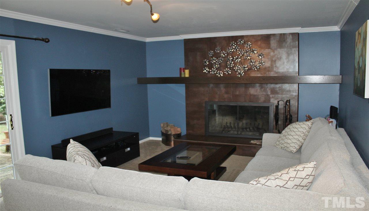 4004 Grimstead Lane Raleigh, NC 27613 - Photo 10 of 25 a living room with furniture and a fireplace