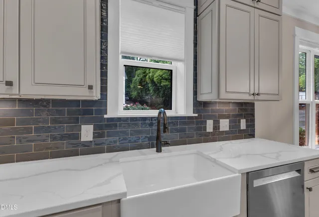 a kitchen with a sink and cabinets