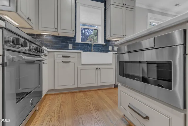 a kitchen with stainless steel appliances a stove and a refrigerator