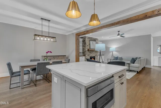 a kitchen with a table chairs and wooden floor