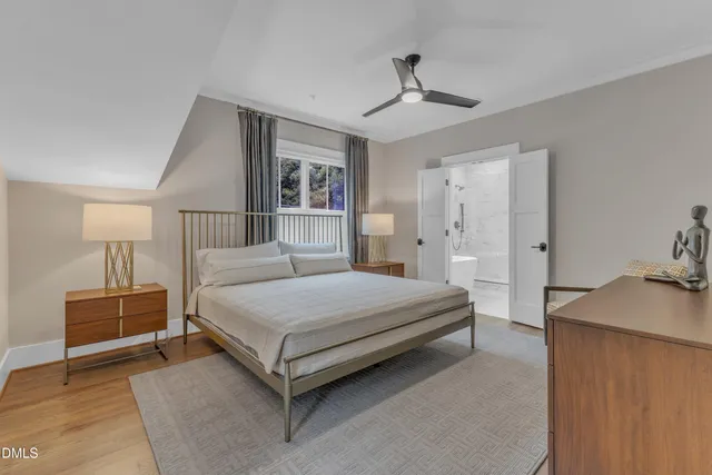 a bedroom with a bed and lamp on table