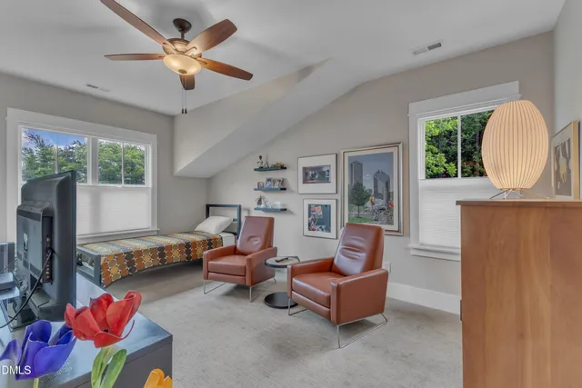 a living room with furniture fireplace and a large window