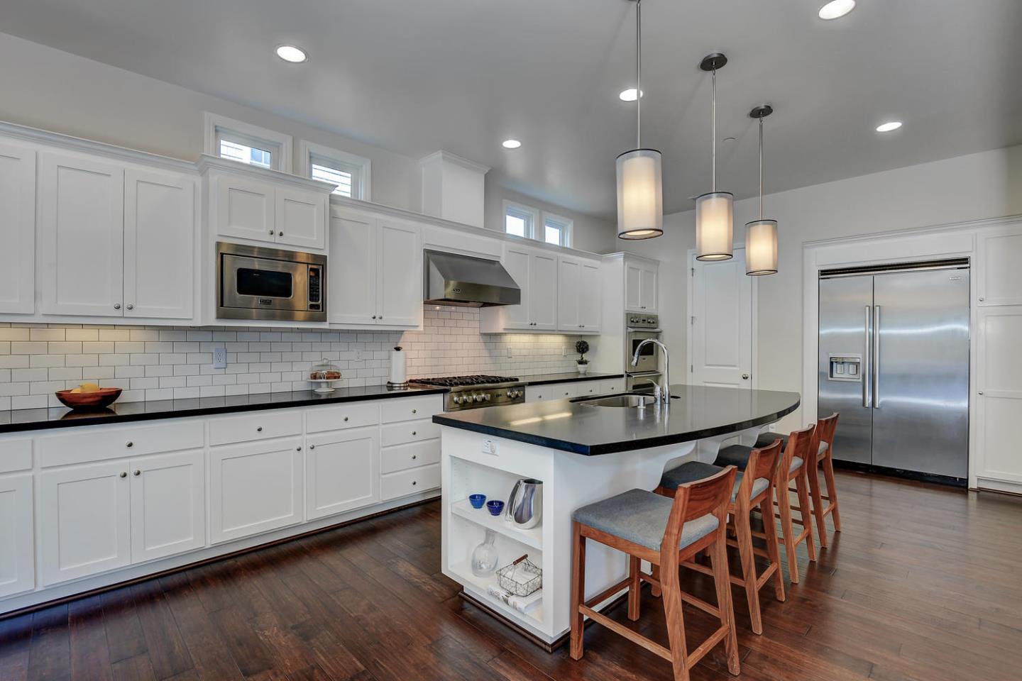 181 Mansfield Drive Mountain View, CA 94040 - Photo 12 of 44 a kitchen with stainless steel appliances granite countertop a stove a sink and a microwave
