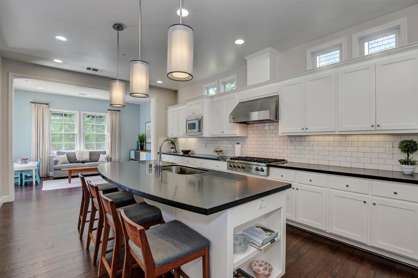 181 Mansfield Drive Mountain View, CA 94040 - Photo 13 of 44 a kitchen with a table chairs microwave and cabinets
