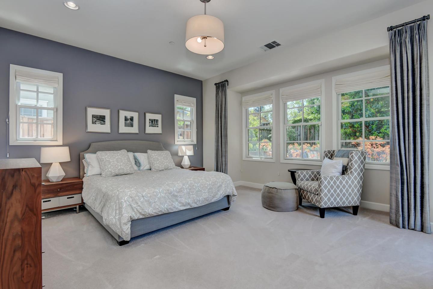 181 Mansfield Drive Mountain View, CA 94040 - Photo 19 of 44 a spacious bedroom with a bed and a chandelier