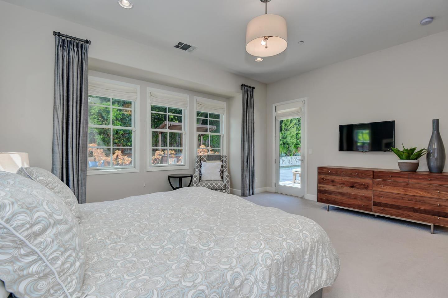 181 Mansfield Drive Mountain View, CA 94040 - Photo 20 of 44 a bedroom with a large bed and flat tv screen