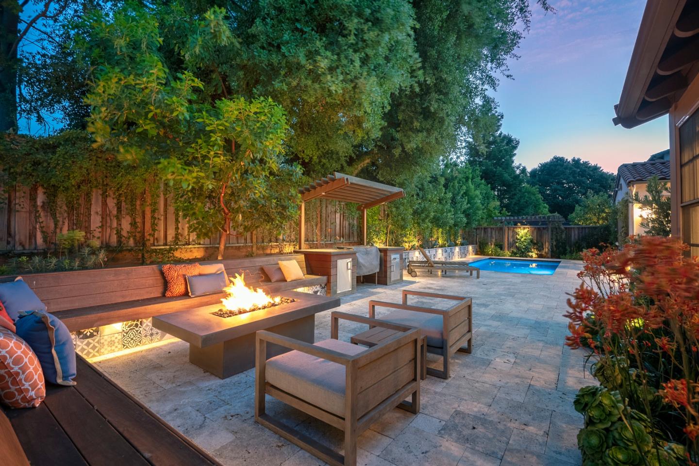 181 Mansfield Drive Mountain View, CA 94040 - Photo 42 of 44 a view of a patio with couches table and chairs under an umbrella with large trees